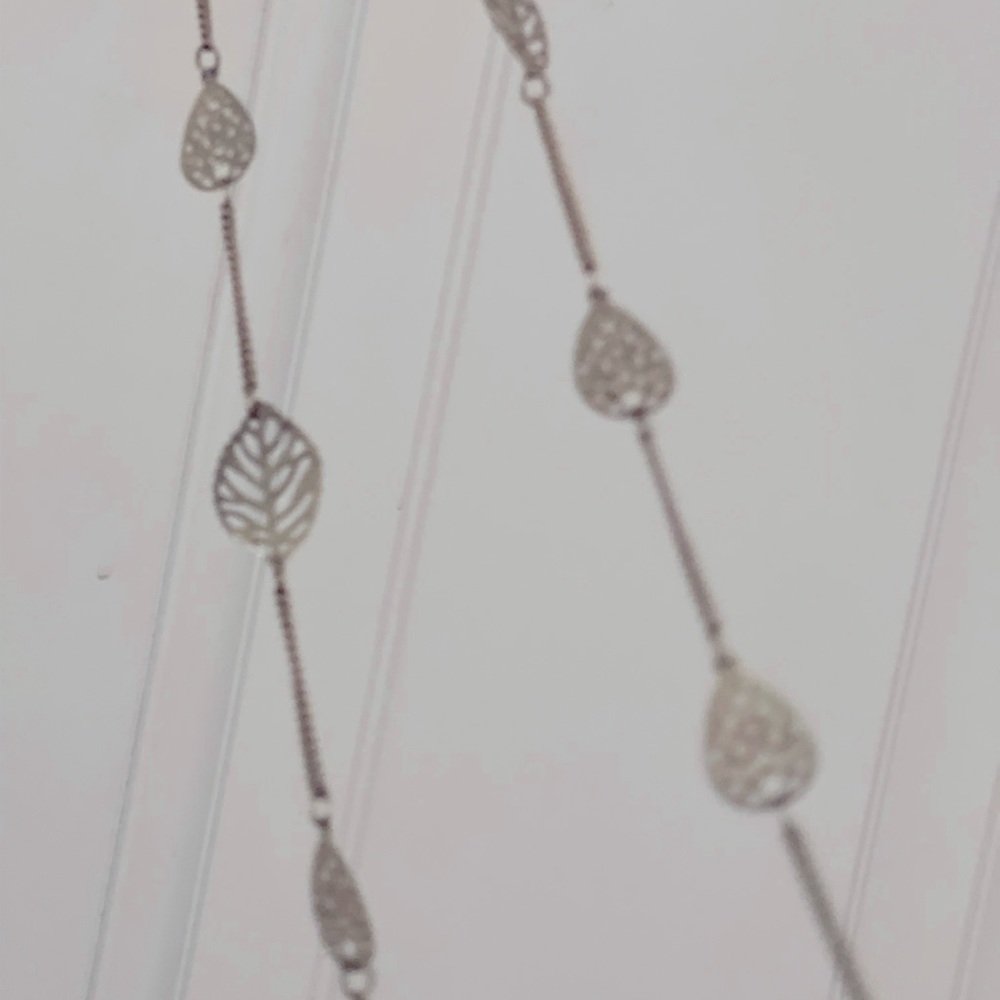 Long, gold, costume jewelry. Leaf detail